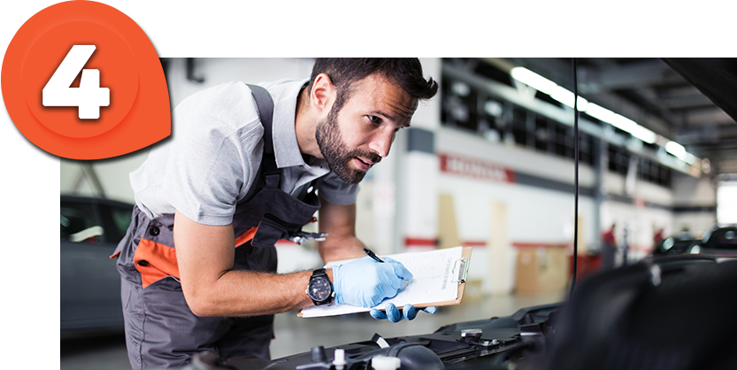 Casa Toyota Technician examining a Kia vehicle